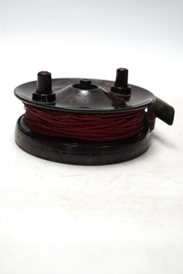 Four fishing reels, including a Bakelite Alcock Aerialite, an Elo, a Seprage C.A.P and a wooden reel, largest 10.5cm diameter. Condition - used, fair